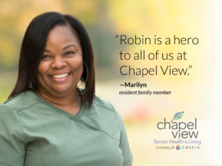 Photo of Robin Woodbury in green scrubs, smiling at the camera. Quote Robin is a hero to all of us at Chapel View.
