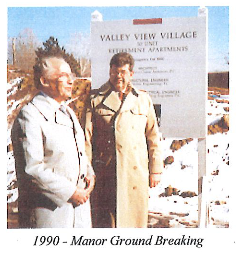 A picture from 1990 of two men posing for The Manor's ground breaking. 