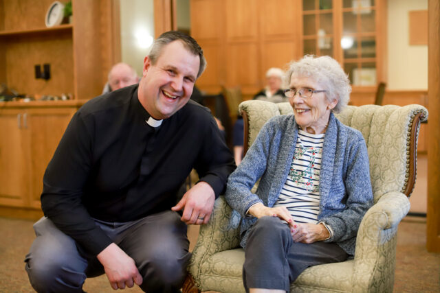 Emerald Crest Chaplain, Pastor Arlen Solem, poses for a picture with resident Roxie.
