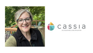 Rev. Julie Ryan, newly appointed Co-VP of Spiritual Life at Cassia, smiles while standing on an outdoor deck. She brings extensive ministry experience, having served ELCA congregations and worked as a Chaplain, to her new role at Cassia's Home Office.