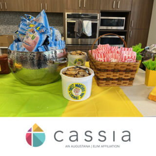 State Fair-inspired picnic setup at Cassia with containers of Sweet Martha’s cookies, bags of cotton candy, and a basket of popcorn on a table, all prepared for employees to enjoy during the event.