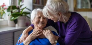 Supportive interaction between a caregiver and loved one in memory care at Meadowview of Clive.