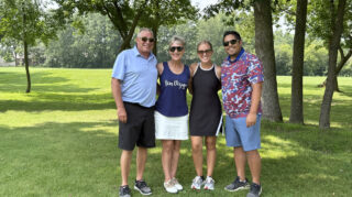 Group of four golfers posing together at the Milaca Elim Meadows Golf Classic.