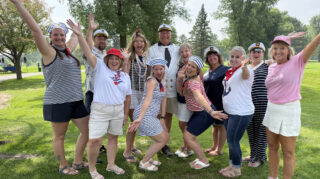 Group in nautical outfits celebrating Bob Dahl at the Milaca Elim Meadows Golf Classic.