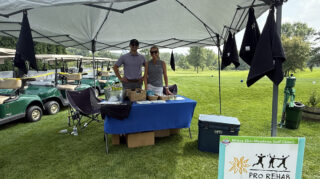 Two sponsors at their booth during the Milaca Elim Meadows Golf Classic.