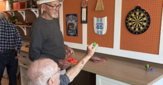 Resident playing magnetic darts