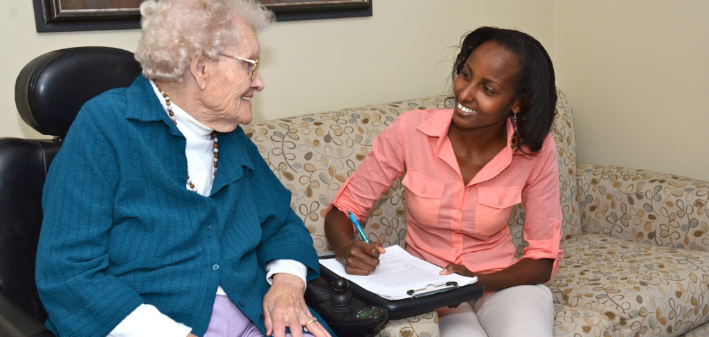 Team member meeting with a resident during onboarding support in a long‑term care community.