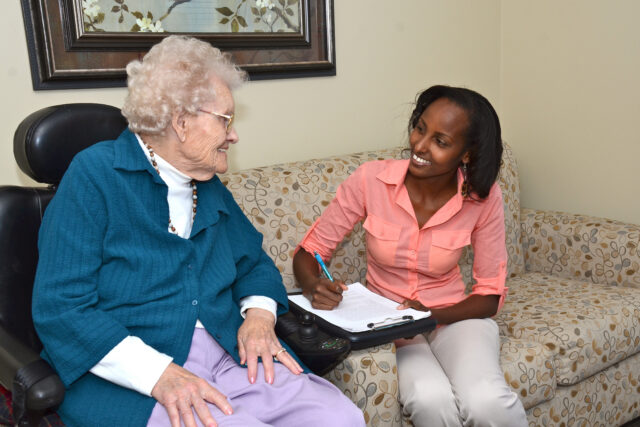 Team member meeting with a resident during onboarding support in a long‑term care community.