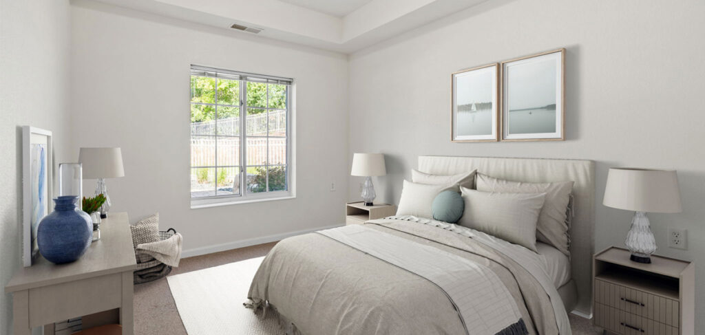 Regent at Burnsville Care Suites, resident bedroom, cozy bedding and bright window view.