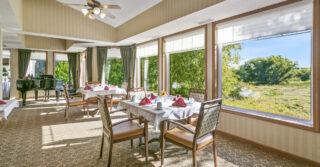 Cornerstone's dining room with many tables set for a meal