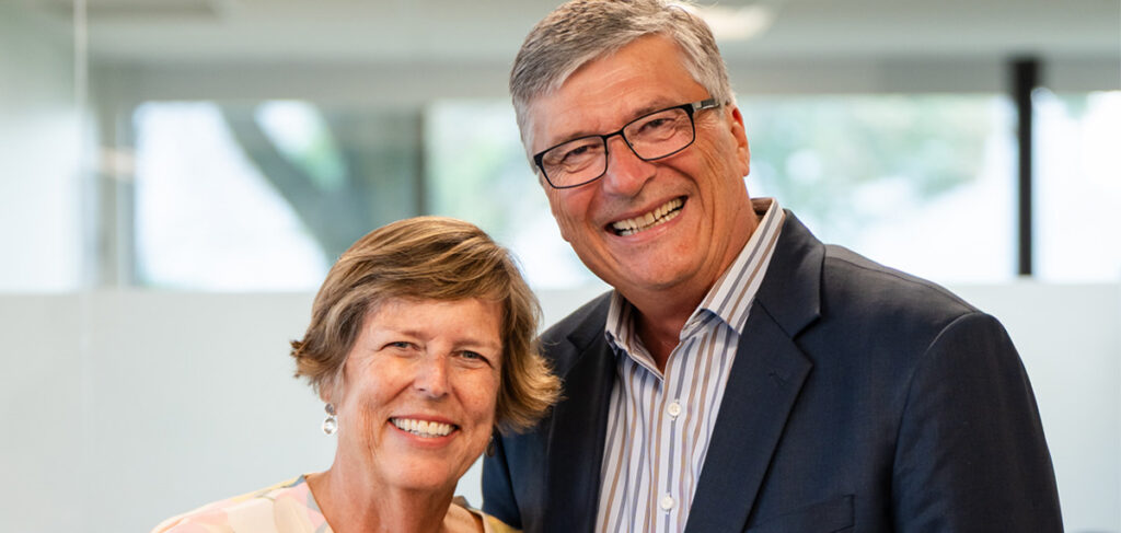 Former Cassia CEO standing with spouse in an office setting