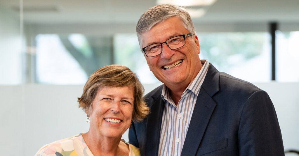 Former Cassia CEO standing with spouse in an office setting