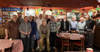 Attendees gathered for a group photo during the EFCA North Central District Conference in a restaurant setting.