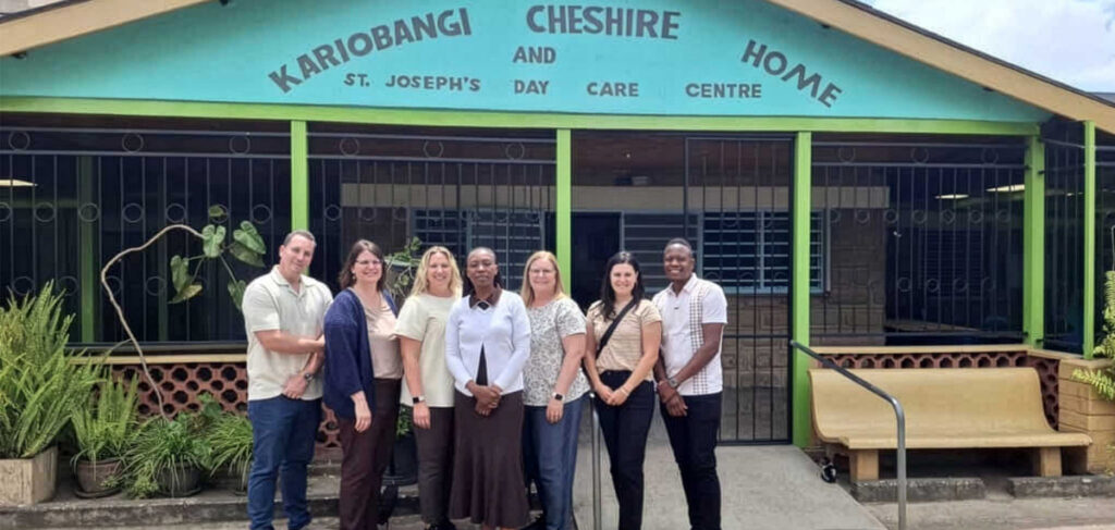 Cassia team visiting Kenya partnership site outside Kariobangi Cheshire Home in Nairobi supporting older adult care through faith service and global collaboration