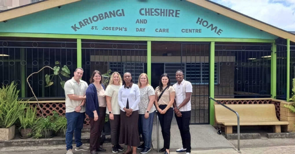 Cassia team visiting Kenya partnership site outside Kariobangi Cheshire Home in Nairobi supporting older adult care through faith service and global collaboration