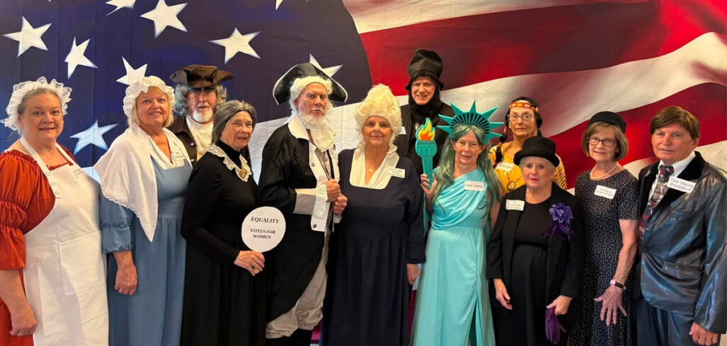 Residents dressed as historical and patriotic figures pose for a group photo during the America 250 celebration at Villas at Stoney Point.