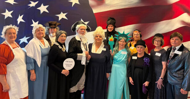 Residents dressed as historical and patriotic figures pose for a group photo during the America 250 celebration at Villas at Stoney Point.