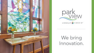 Park View promotional graphic featuring a stained-glass chapel window, a wooden table with an open book and flowers, and the text “We bring Innovation.”